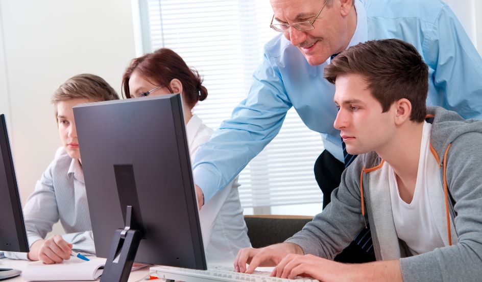 instructor training student on computer