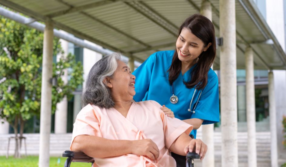 healthcare professional helping senior woman sitting