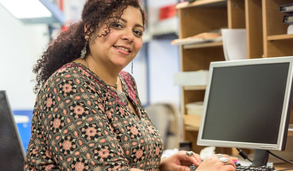 medical transcriptionist sitting at computer typing