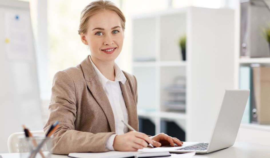 female accountant sitting at a desk in front of a laptop