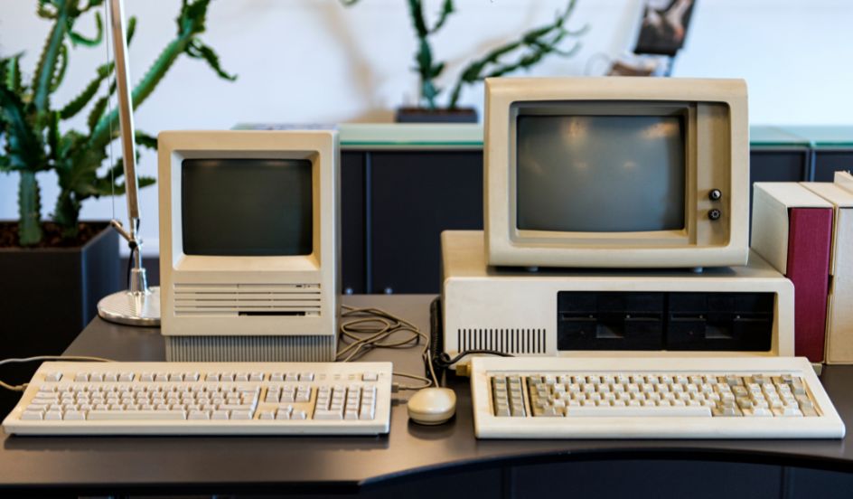 two old computers on a desk