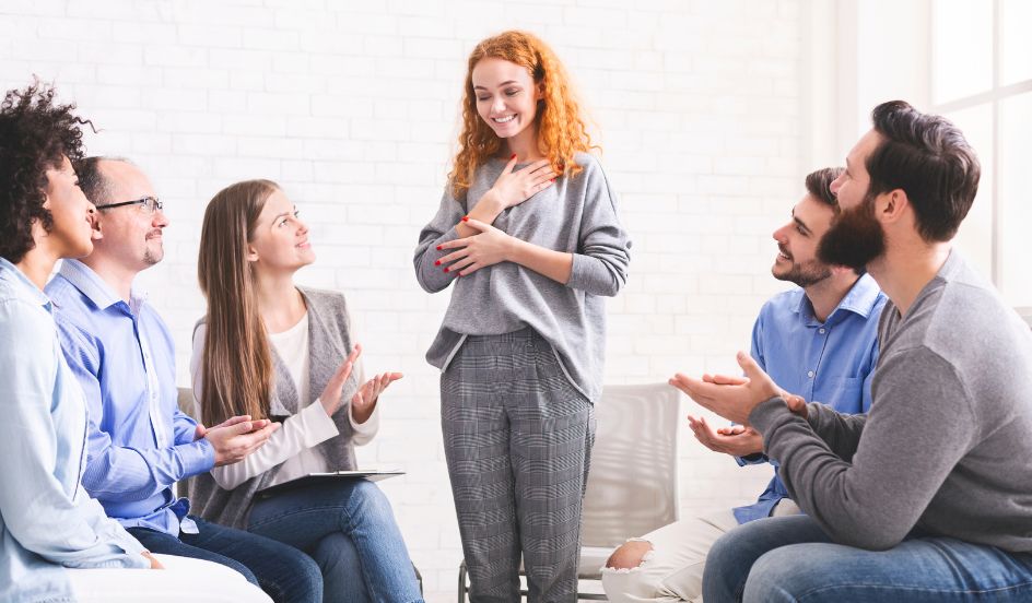 woman standing in front of addiction support group