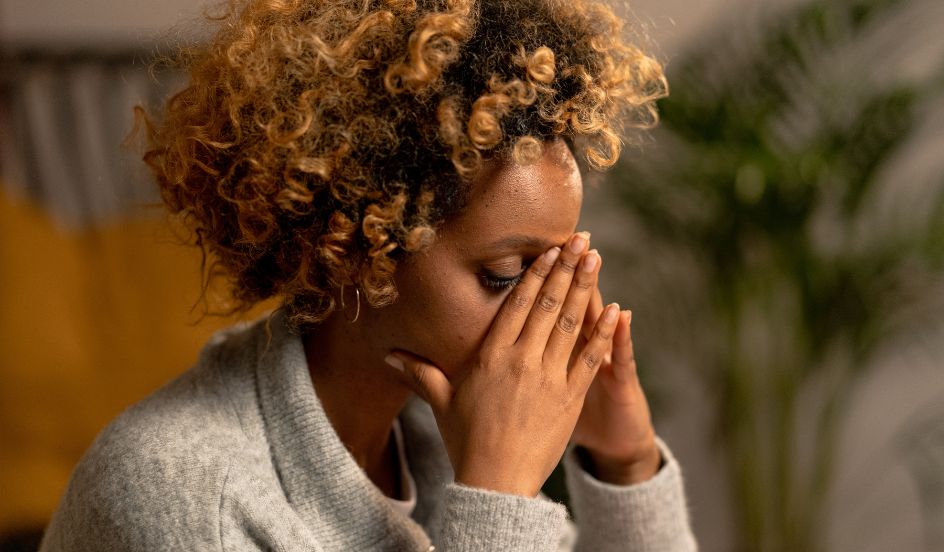 woman with hands on face stressed