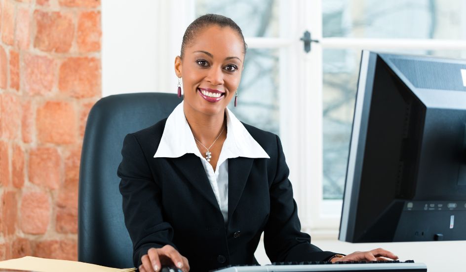female paralegal sitting at a desk in front of a computer