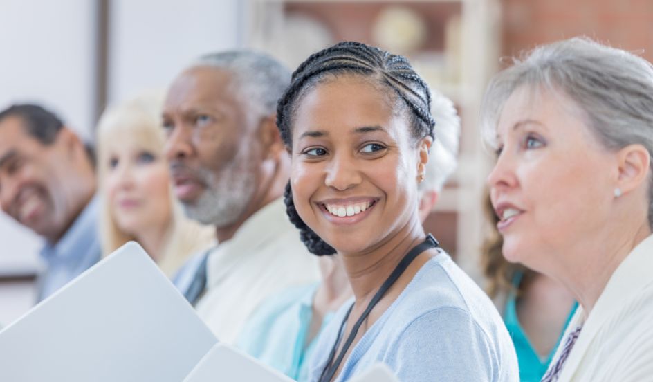 woman smiling sitting in a classroom