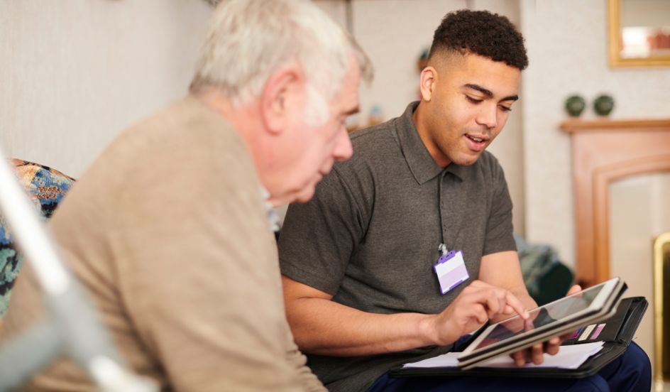 psw helping senior using tablet