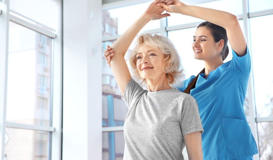 Physiotherapist helping senior patient