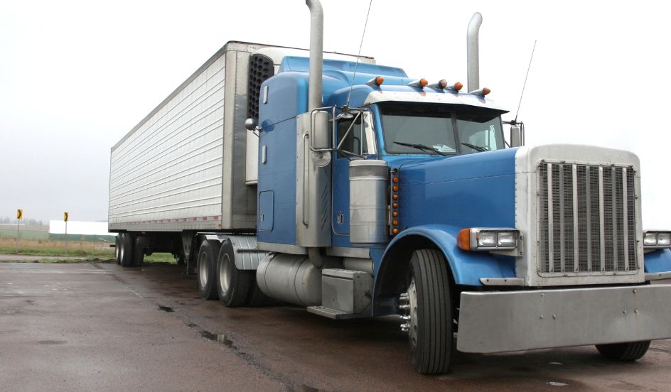 blue truck cab with white trailer