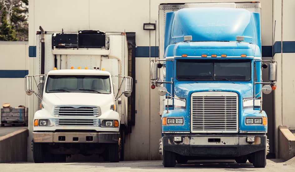 two trucks backed into shipping bay