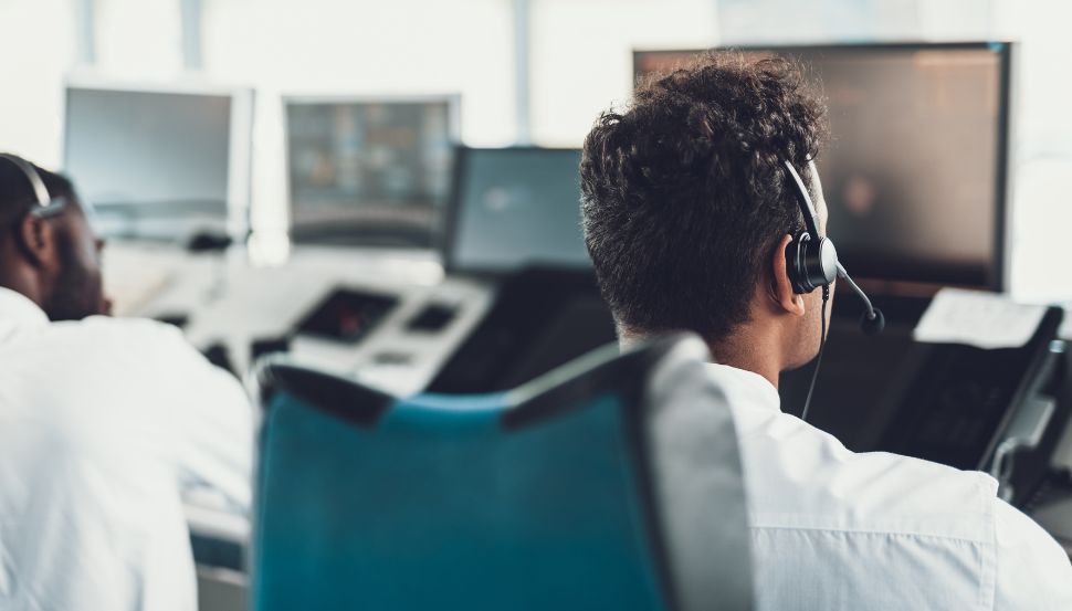 dispatcher sitting at computer with headset on