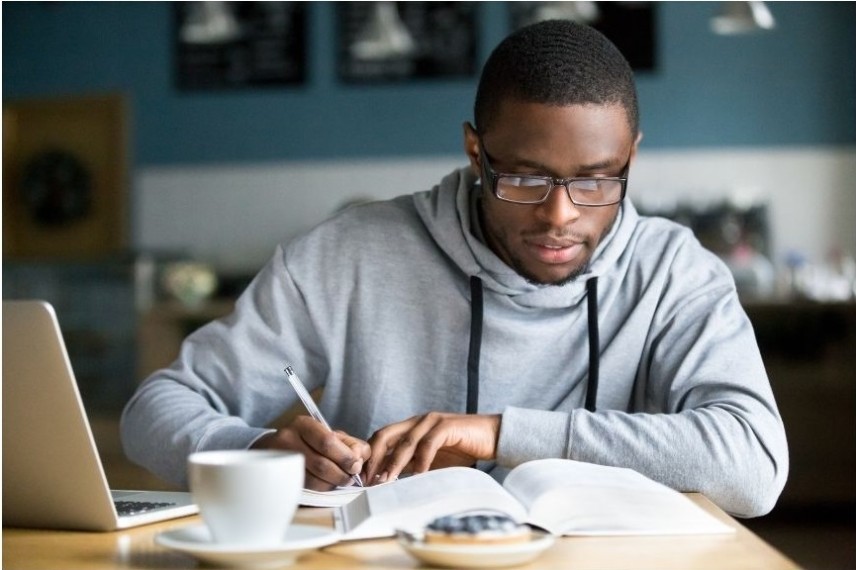 A guy studies alone for online class.