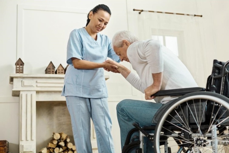A personal support worker assists a client to stand up