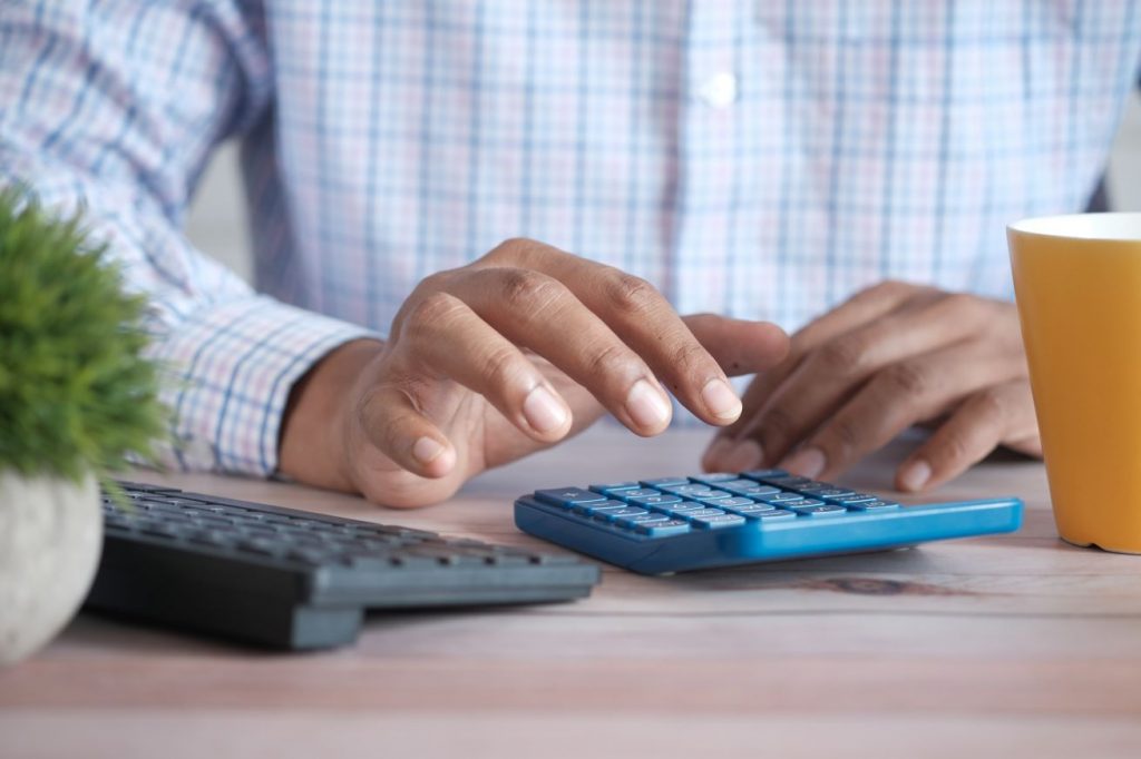 Accounting Specialist using a calculator