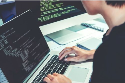 Web Developer web developer coding on a laptop