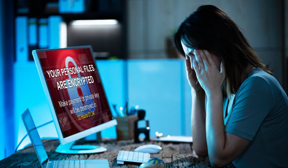 woman sitting in front of her computer with her face on her hands